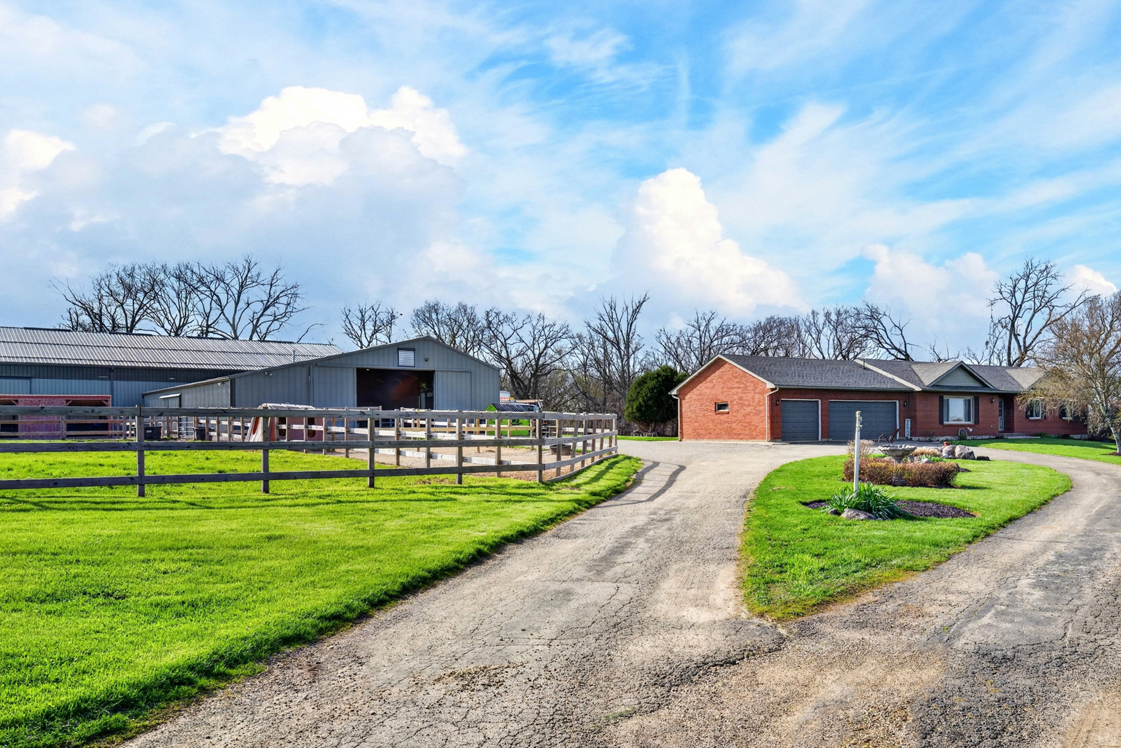 a front view of a house with a yard and green space