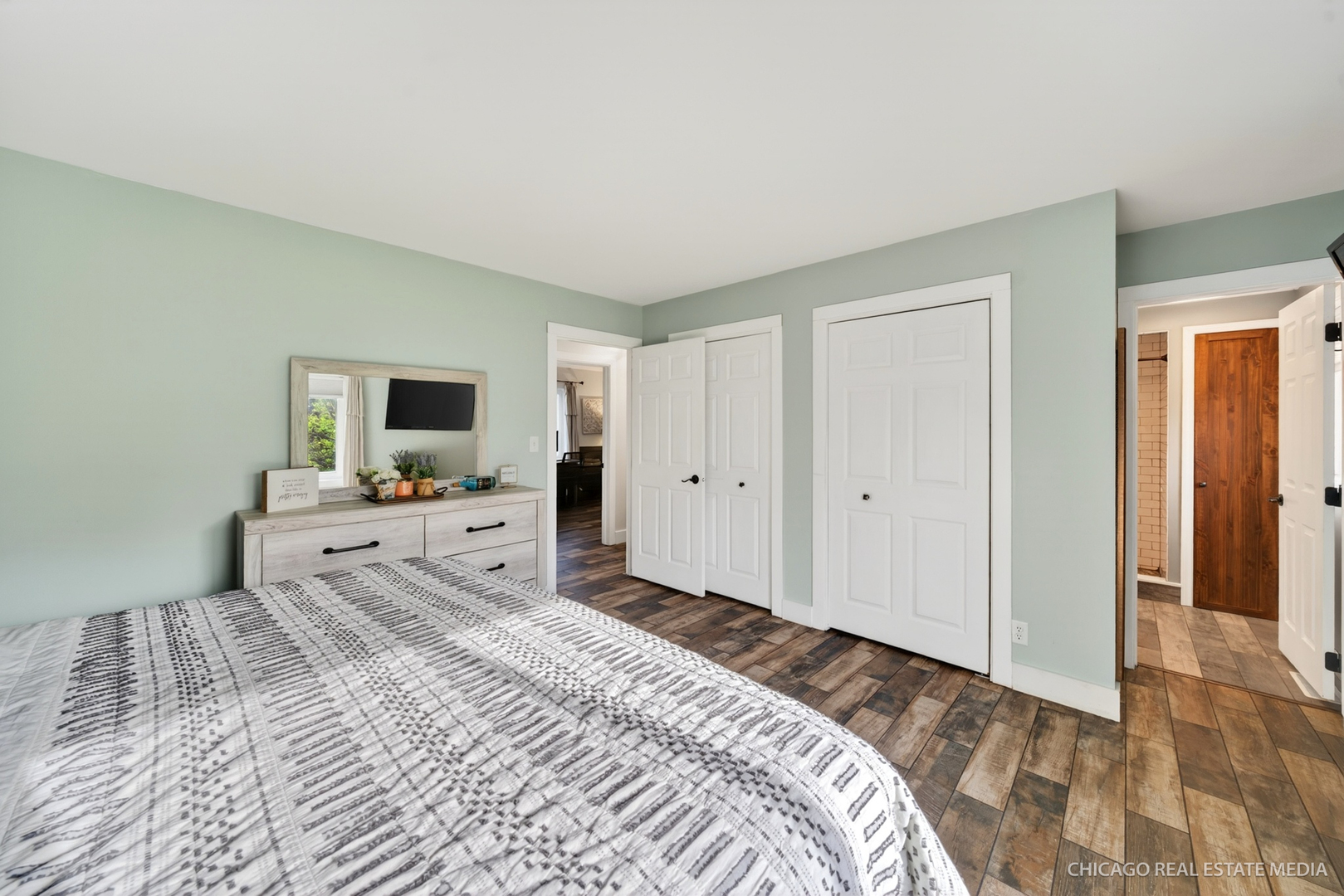 1513 Deerpass Road Marengo, IL 60152 - Photo 19 of 48 a view of a bedroom with a large bed and a flat screen tv