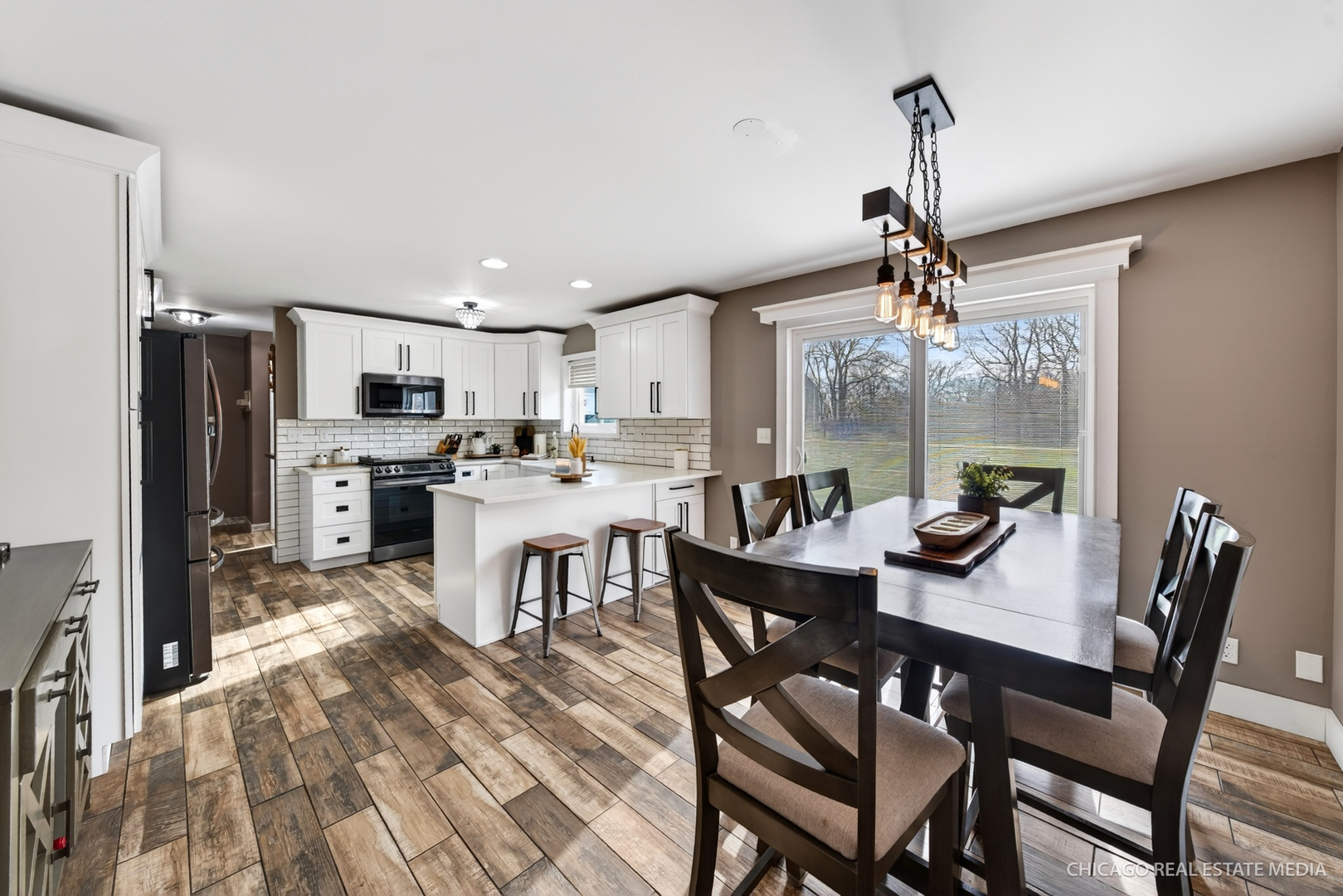 1513 Deerpass Road Marengo, IL 60152 - Photo 6 of 48 a kitchen with a dining table chairs and refrigerator