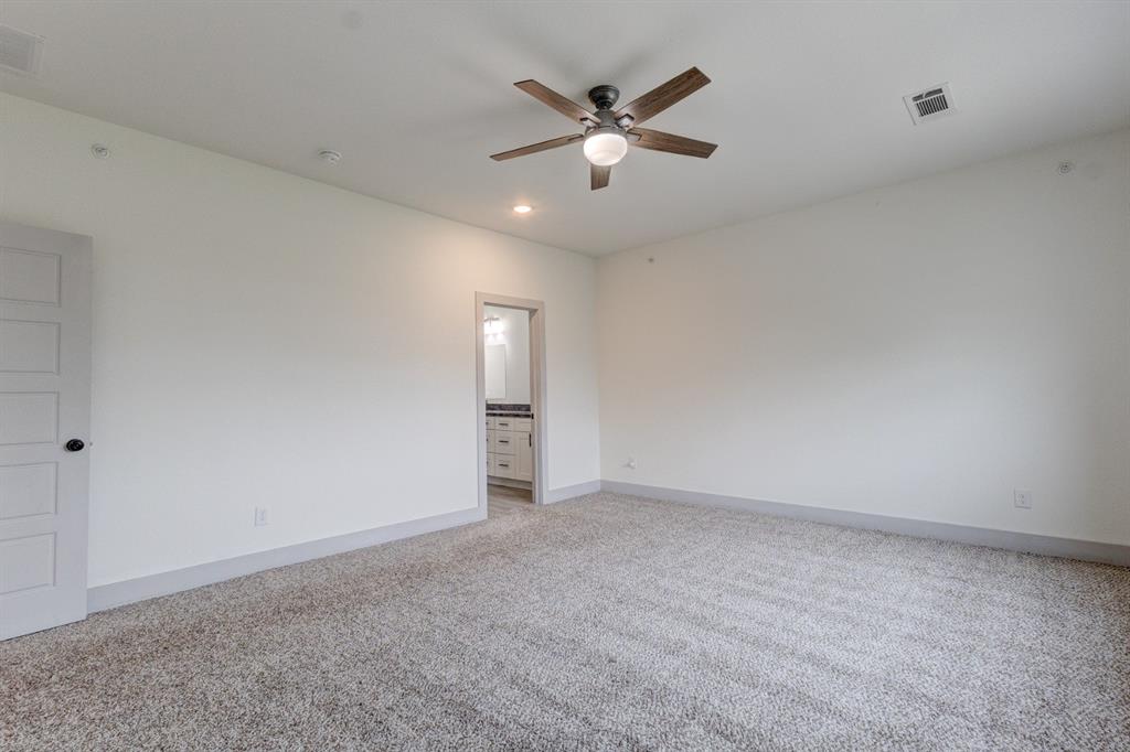 6043 Rivendell Drive Frisco, TX 75035 - Photo 23 of 38 an empty room with a ceiling fan and a window