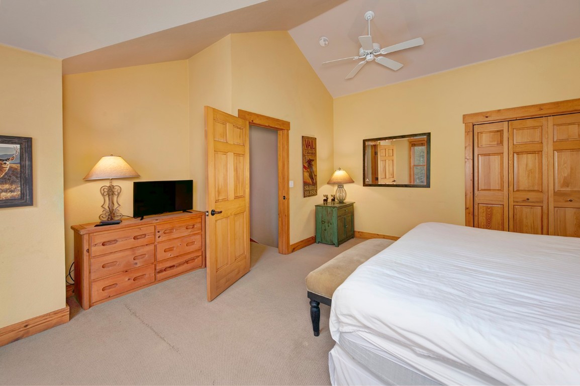 28 Trappers Crossing Trail, Unit 8760 Keystone, CO 80435 - Photo 19 of 37 a bedroom with a bed and a dresser