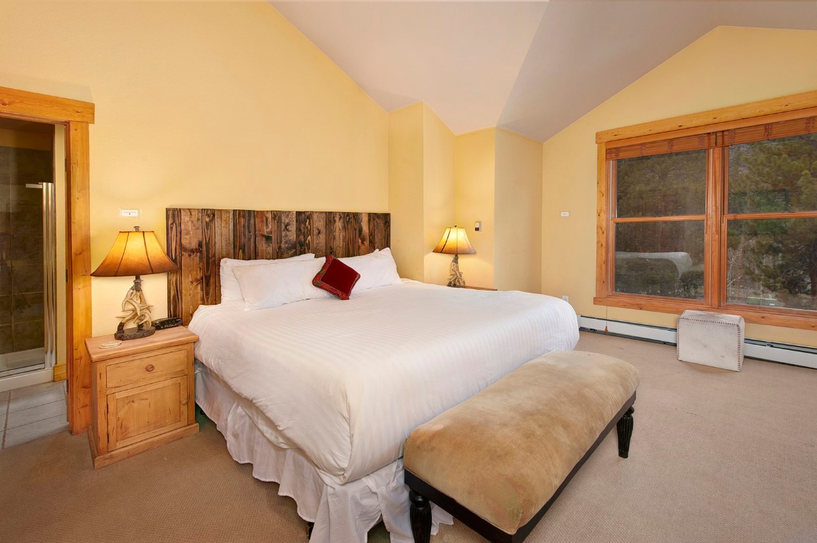 28 Trappers Crossing Trail, Unit 8760 Keystone, CO 80435 - Photo 22 of 37 a bedroom with a bed and window