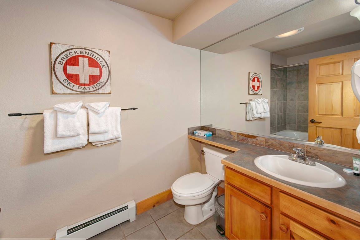 28 Trappers Crossing Trail, Unit 8760 Keystone, CO 80435 - Photo 26 of 37 a bathroom with a toilet a sink and a mirror