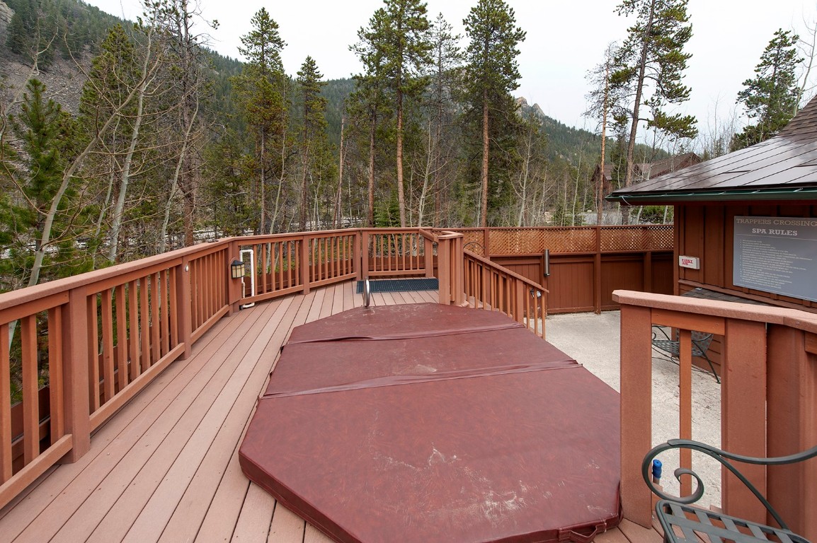 28 Trappers Crossing Trail, Unit 8760 Keystone, CO 80435 - Photo 33 of 37 a view of balcony with wooden floor and barbeque oven