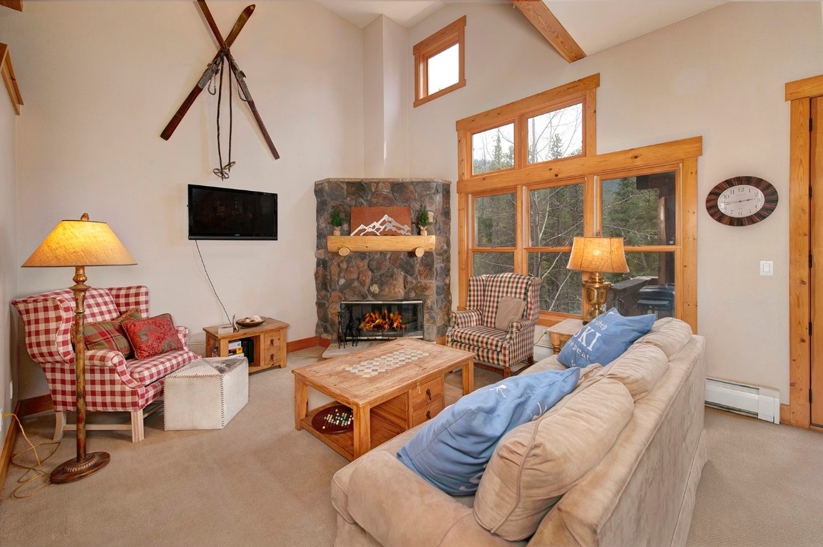 28 Trappers Crossing Trail, Unit 8760 Keystone, CO 80435 - Photo 4 of 37 a living room with furniture a fireplace and a flat screen tv