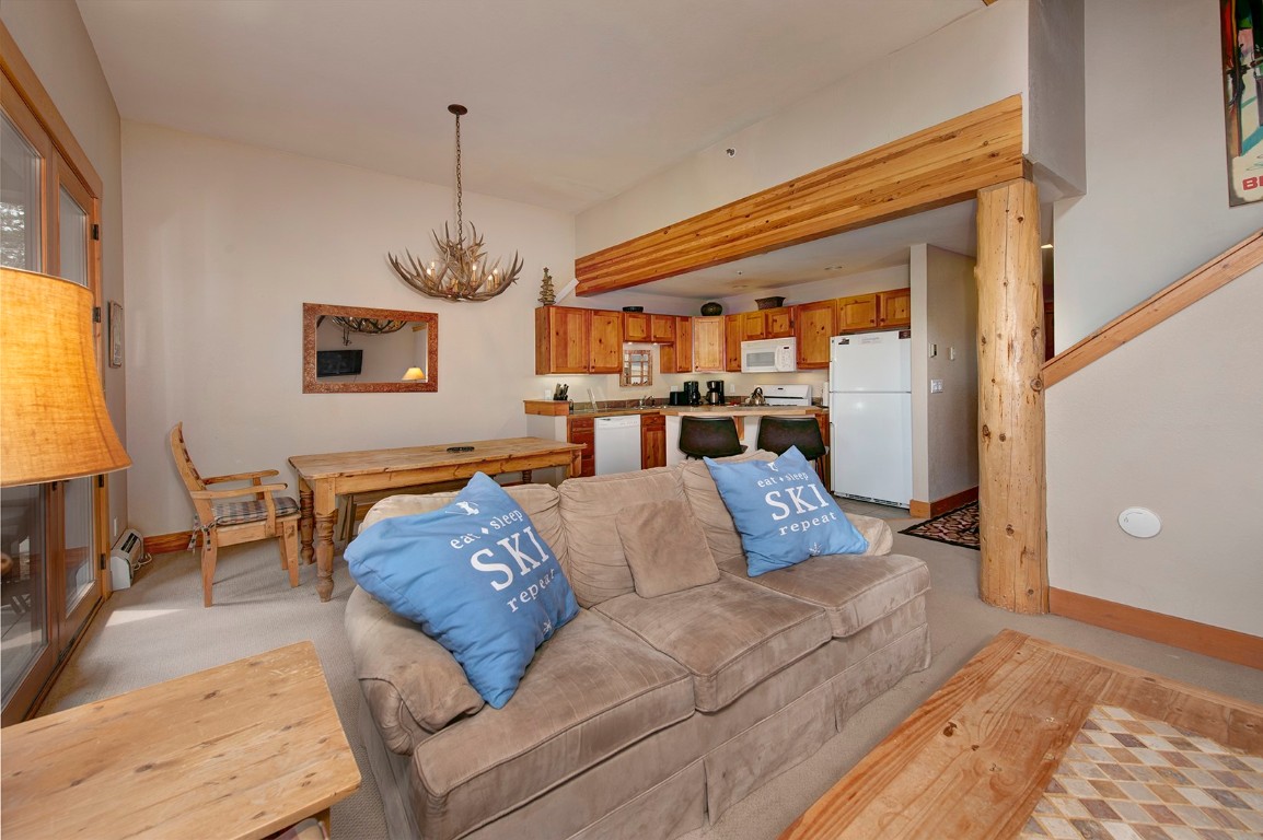 28 Trappers Crossing Trail, Unit 8760 Keystone, CO 80435 - Photo 9 of 37 a living room with furniture and a chandelier
