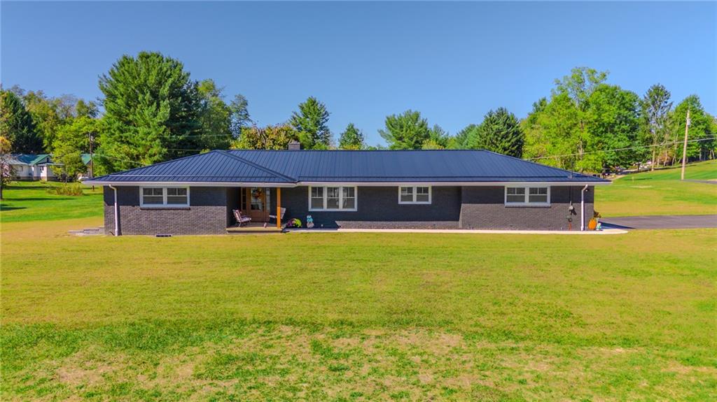 7 Indian Lane Vanderbilt, PA 15486 - Photo 1 of 38 a front view of a house with a garden