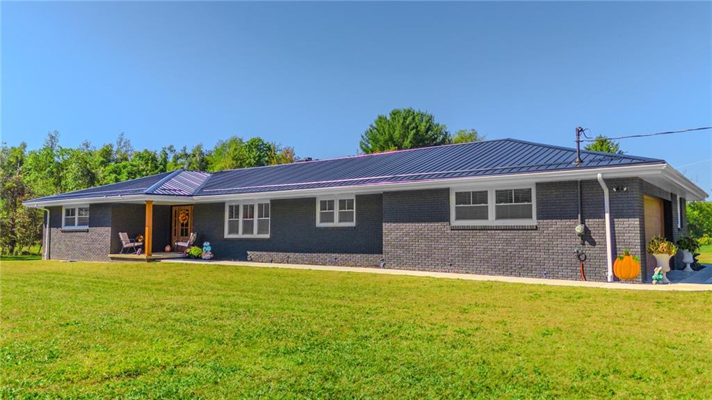 7 Indian Lane Vanderbilt, PA 15486 - Photo 2 of 38 a front view of house with yard outdoor seating and barbeque oven
