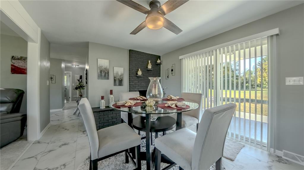 7 Indian Lane Vanderbilt, PA 15486 - Photo 22 of 38 a dining room with furniture a chandelier and wooden floor