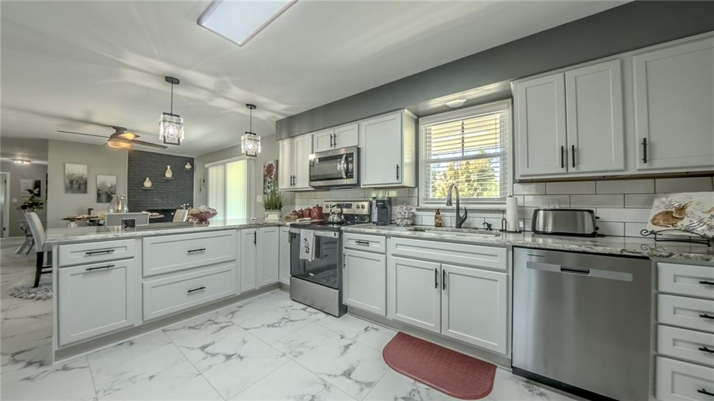 7 Indian Lane Vanderbilt, PA 15486 - Photo 26 of 38 a kitchen with granite countertop white cabinets white appliances with a sink and dishwasher