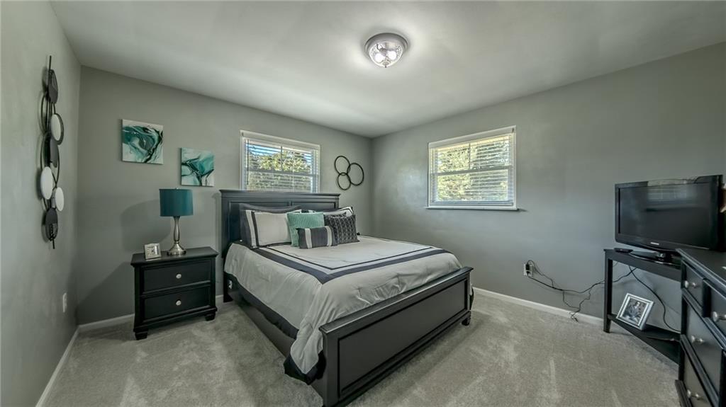 7 Indian Lane Vanderbilt, PA 15486 - Photo 32 of 38 a bedroom with a bed and a tv on the dresser