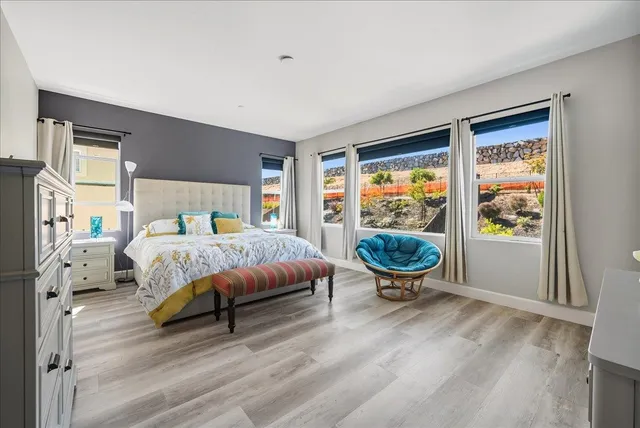 a spacious bedroom with a bed and a couch