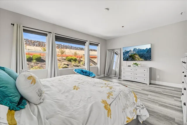 a bathroom with a granite countertop sink a toilet a mirror and vanity