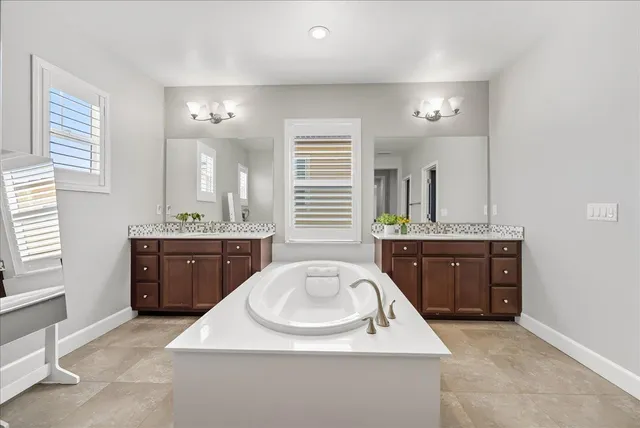 a bathroom with a tub and a shower
