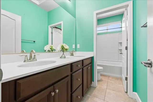 a spacious bedroom with a bed and a dresser in it