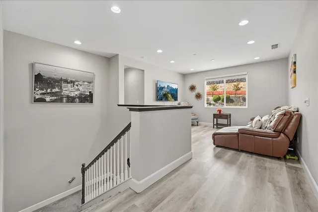 a view of a hallway with wooden floor