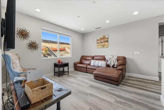 a living room with patio furniture and a floor to ceiling window