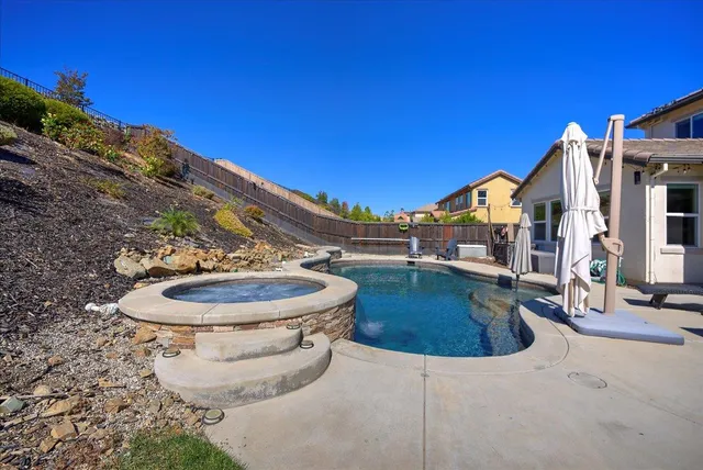 a view of a swimming pool with a chair and tables