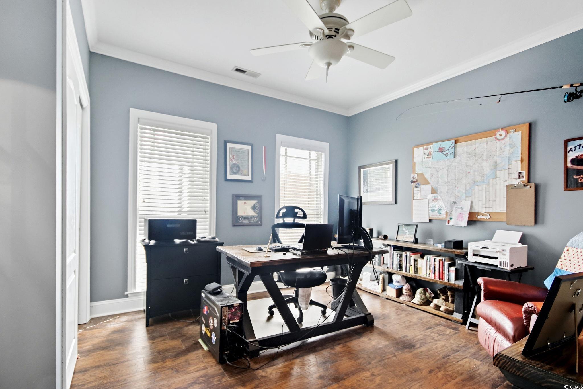 21 Craftsman Lane Georgetown, SC 29440 - Photo 20 of 39 Office area with crown molding, dark wood-style flooring, and ceiling fan