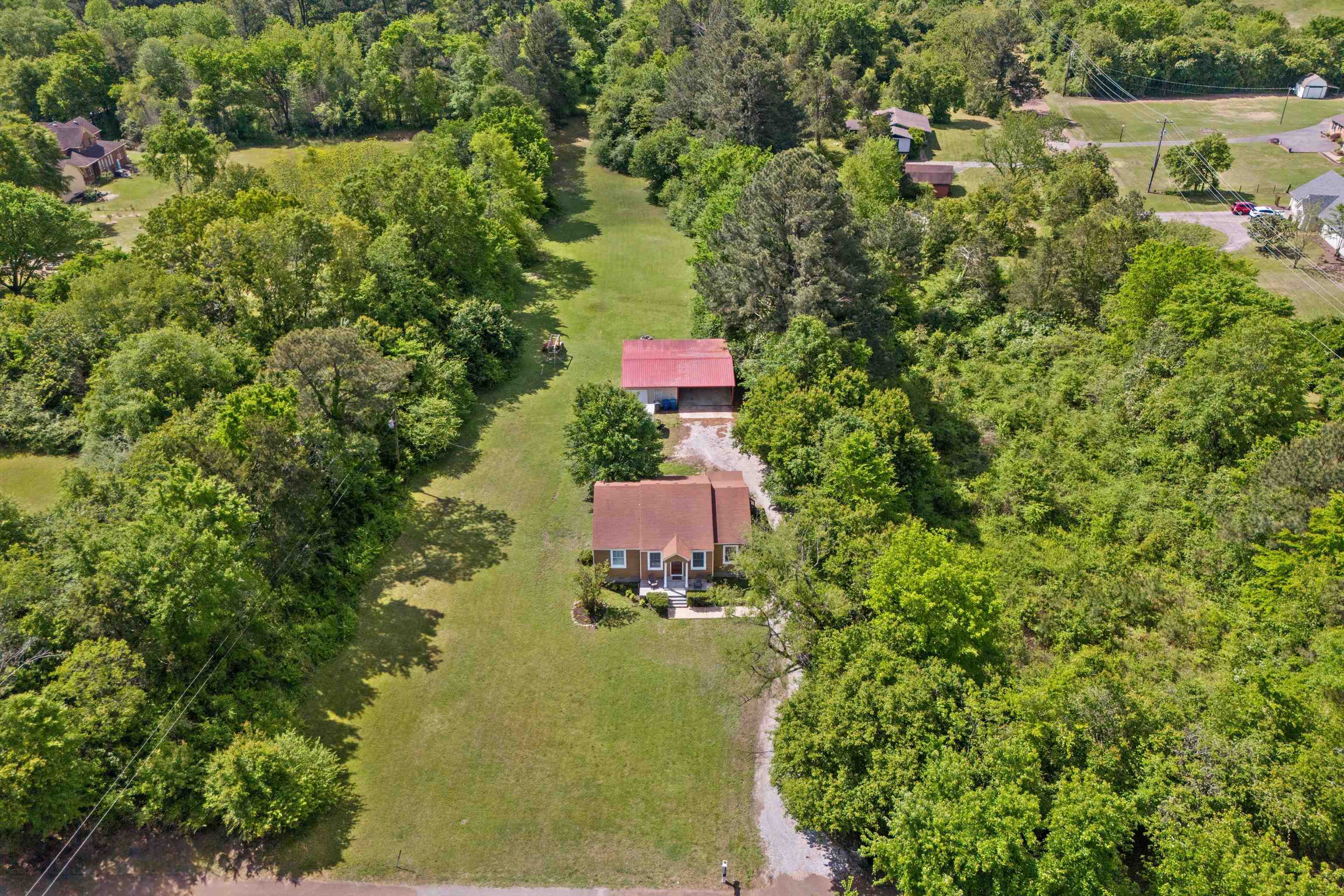 an aerial view of a house with a yard swimming pool and lake view