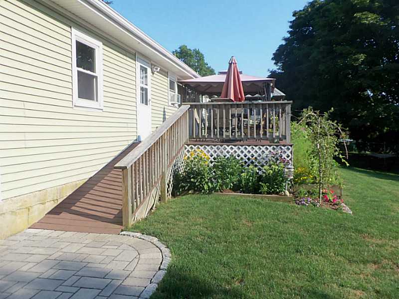 171 Valley Road Middletown, RI 02842 - Photo 4 of 25 Patio/Deck. Ramp leads to the 48 x 12 deck with built in Grilling Area and Bar.The Back Yard is completely fenced in and there is plenty of room for flower and vegetable gardens yards.