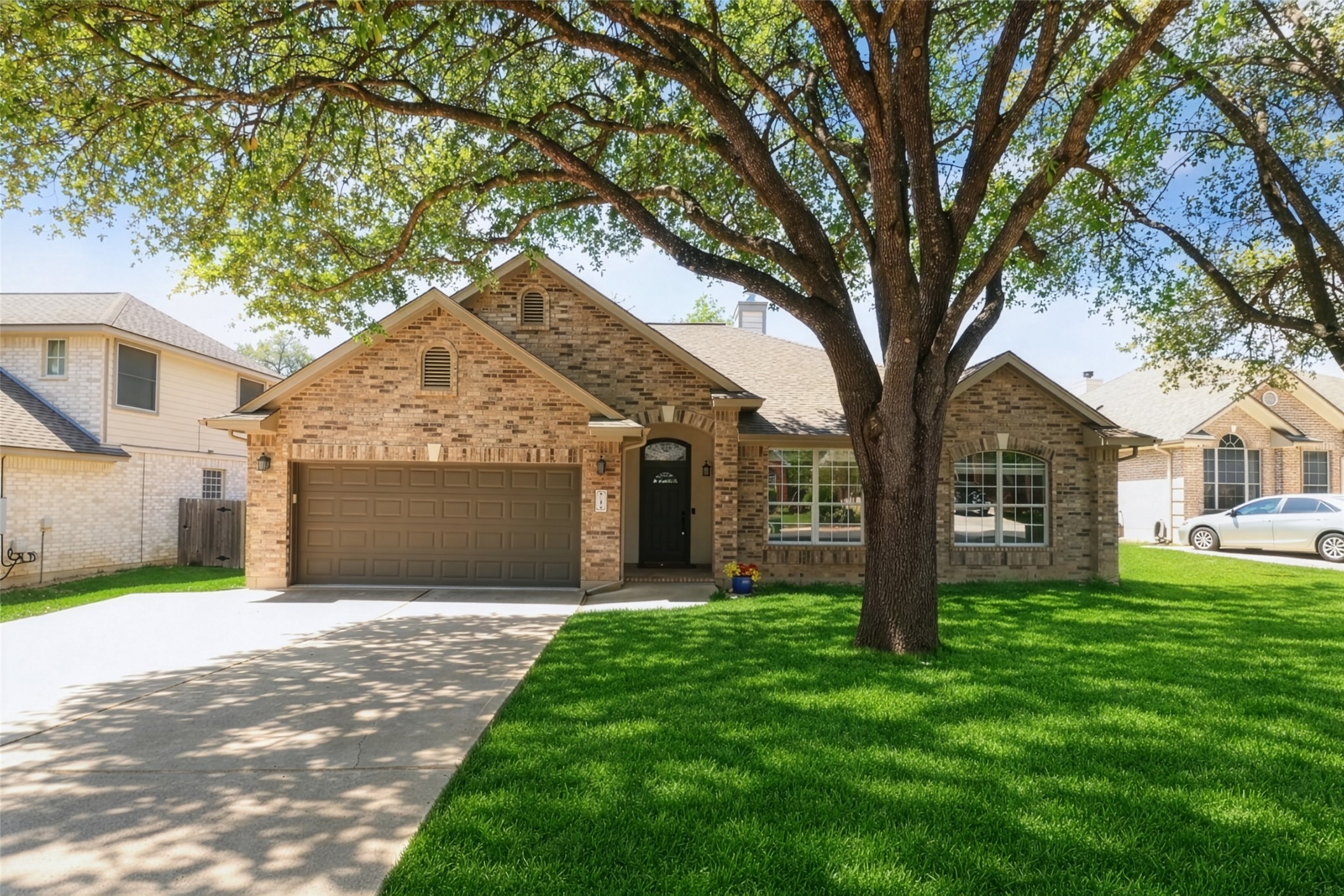 11918 Arbor Downs Road Austin, TX 78748 - Photo 1 of 29 Photo has been enhanced. View of front facade featuring driveway, brick siding, and a garage
