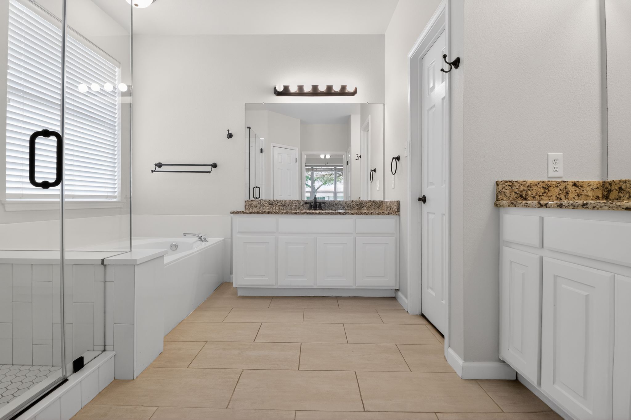 11918 Arbor Downs Road Austin, TX 78748 - Photo 20 of 29 Full bathroom featuring a garden tub, vanity, a stall shower, and light tile patterned floors