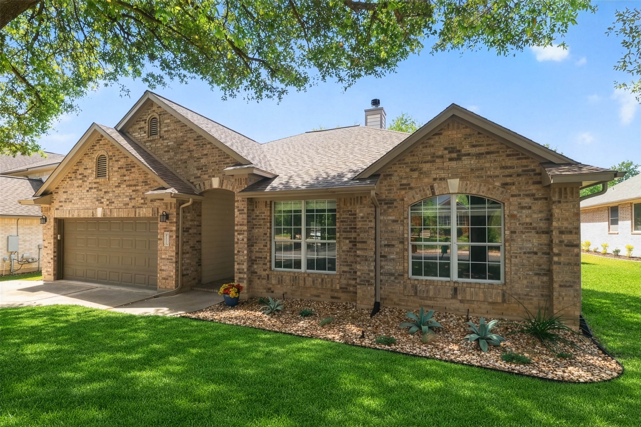 11918 Arbor Downs Road Austin, TX 78748 - Photo 2 of 29 Photo has been enhanced. View of front of house with brick siding, a front lawn, a chimney, a garage, and roof with shingles