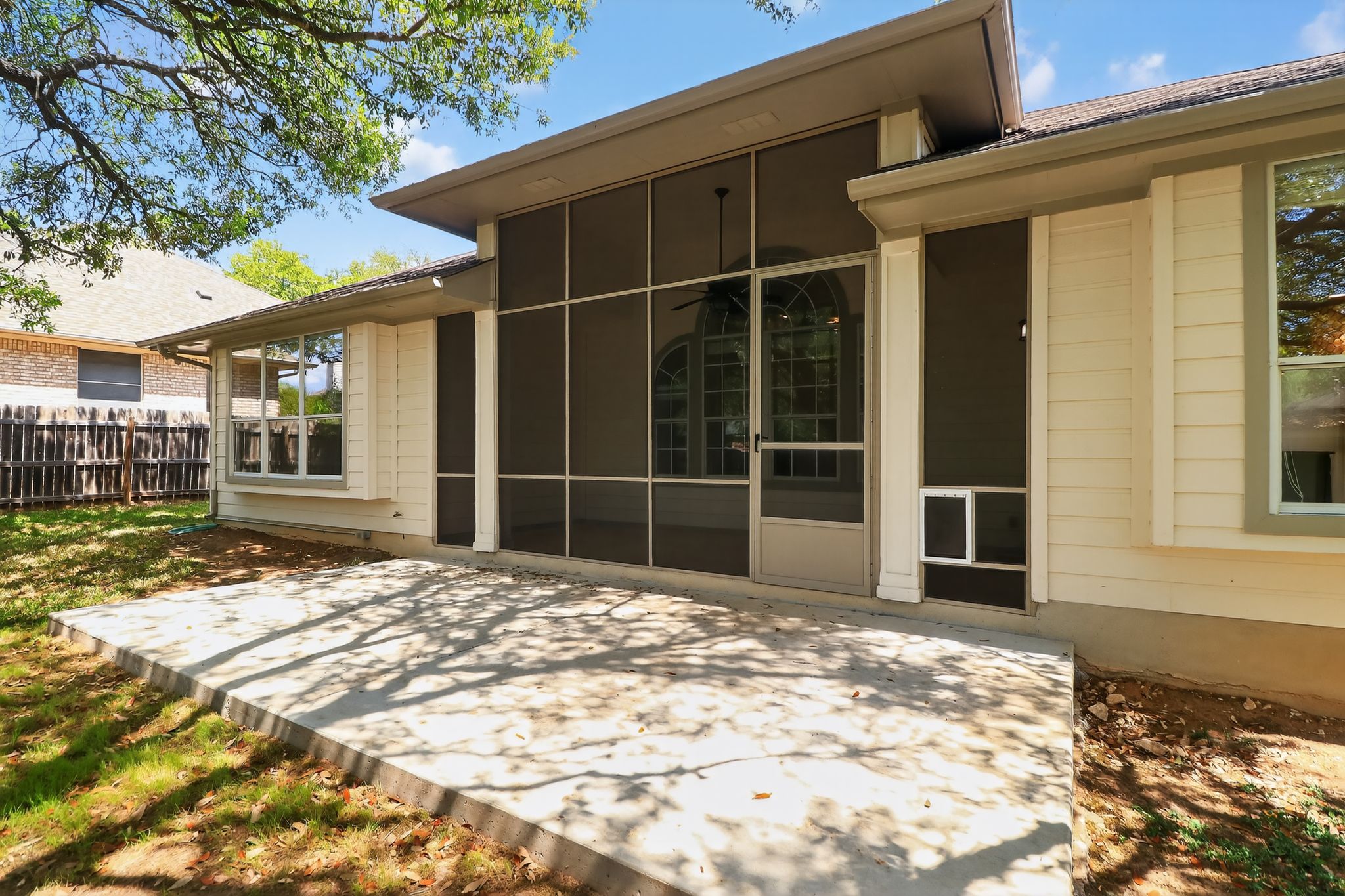 11918 Arbor Downs Road Austin, TX 78748 - Photo 27 of 29 Back of property featuring a patio and a sunroom