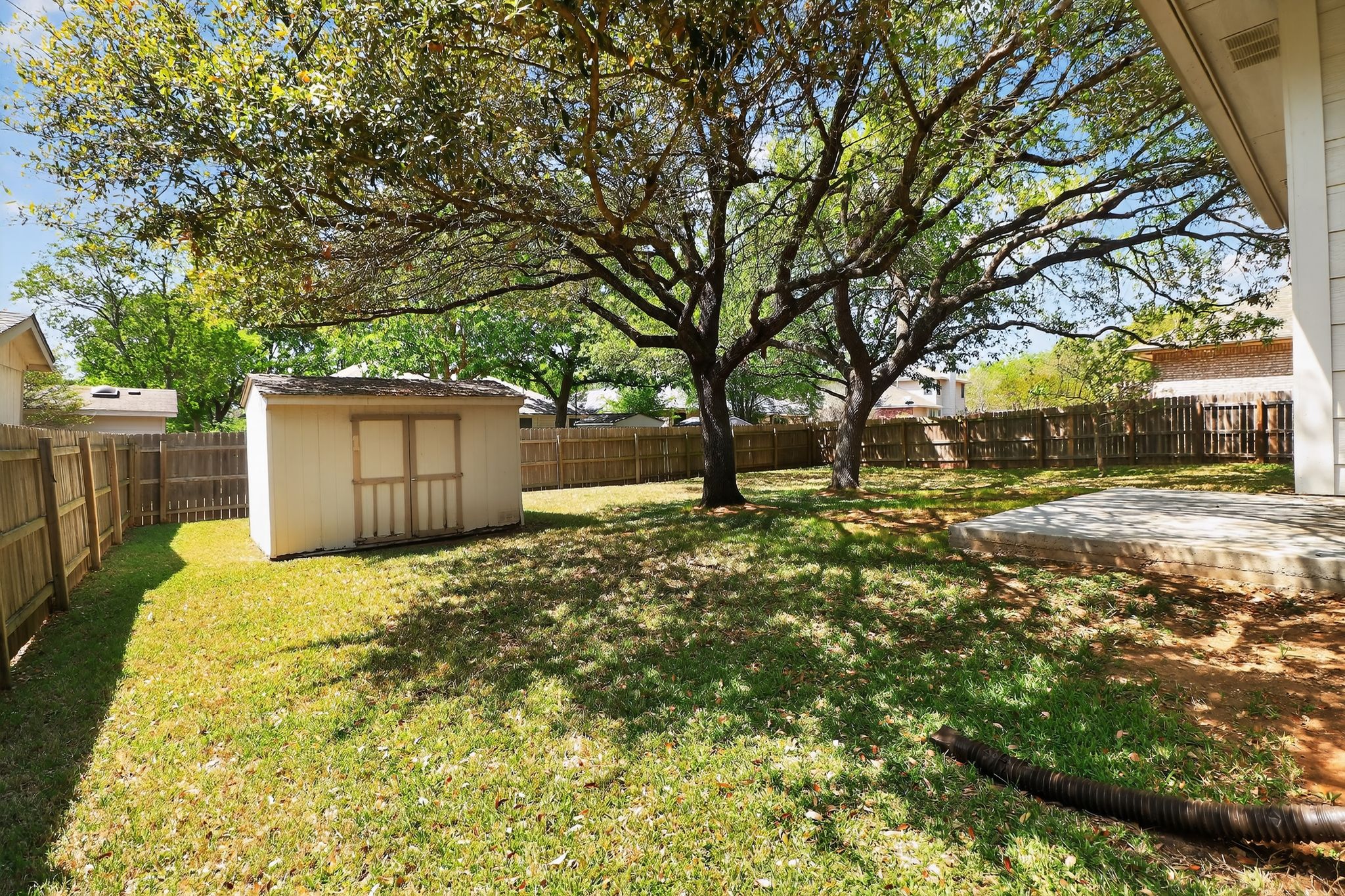 11918 Arbor Downs Road Austin, TX 78748 - Photo 28 of 29 Fenced backyard with a shed and a patio area