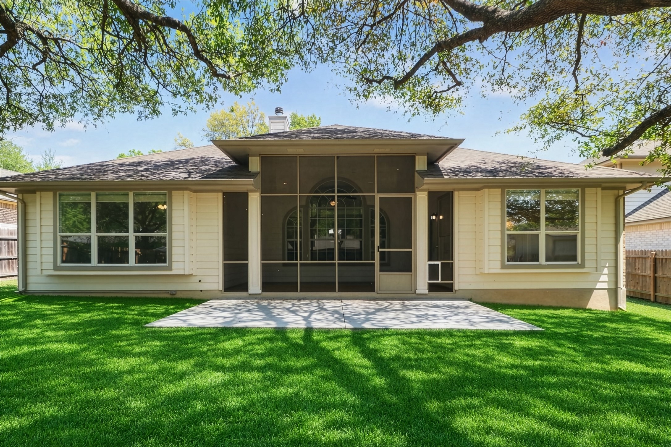 11918 Arbor Downs Road Austin, TX 78748 - Photo 3 of 29 Photo has been enhanced. Back of house featuring a patio area, a sunroom, and a chimney