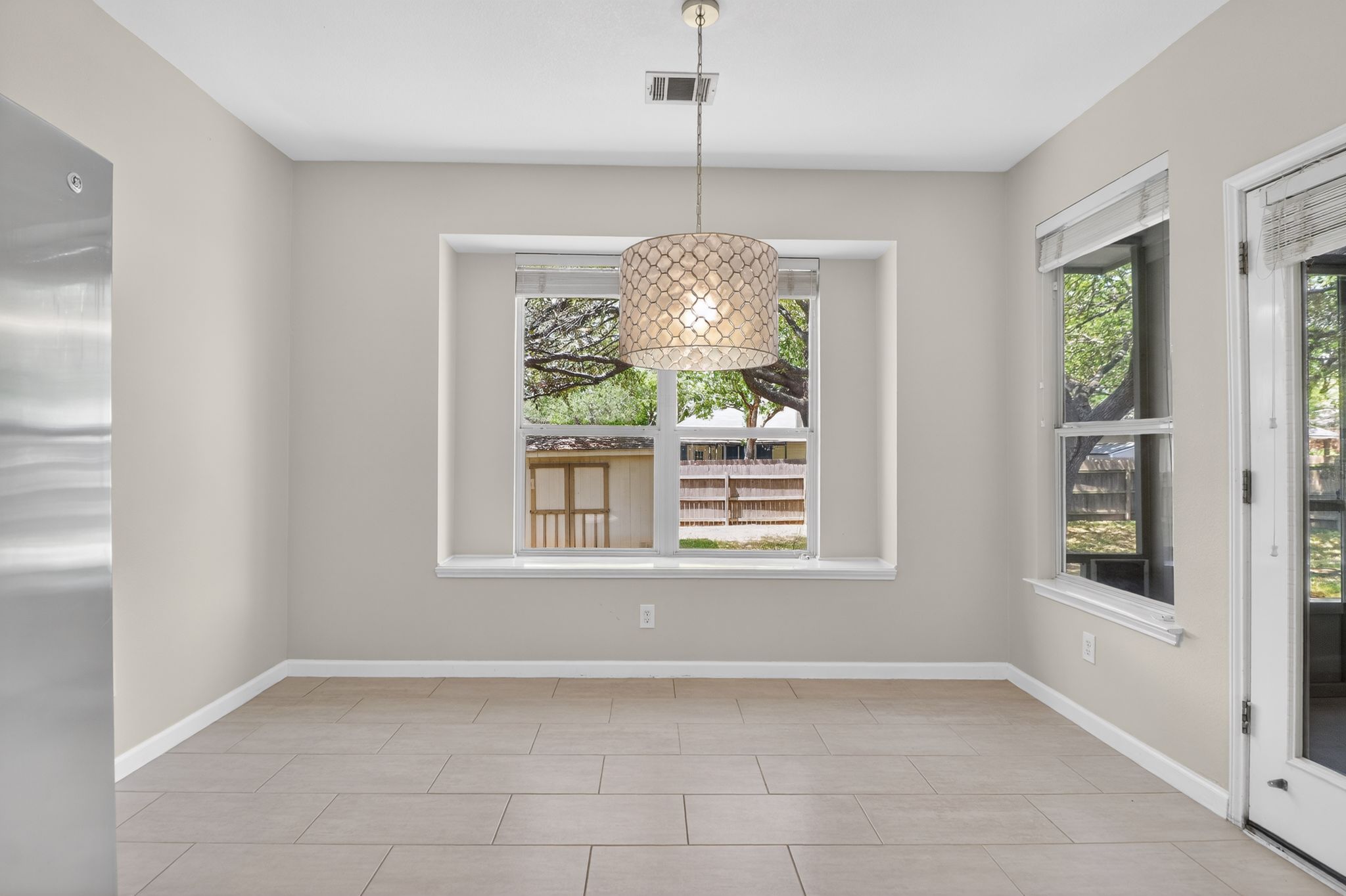 11918 Arbor Downs Road Austin, TX 78748 - Photo 10 of 29 dining area with baseboards and light tile patterned flooring