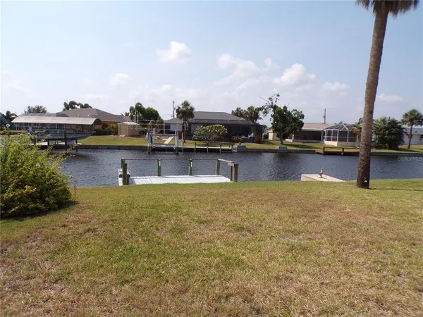 a swimming pool with outdoor seating and yard