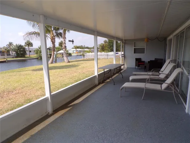 a living room with furniture and a floor to ceiling window