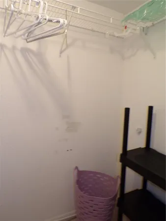 a view of a room with a wooden table and chair