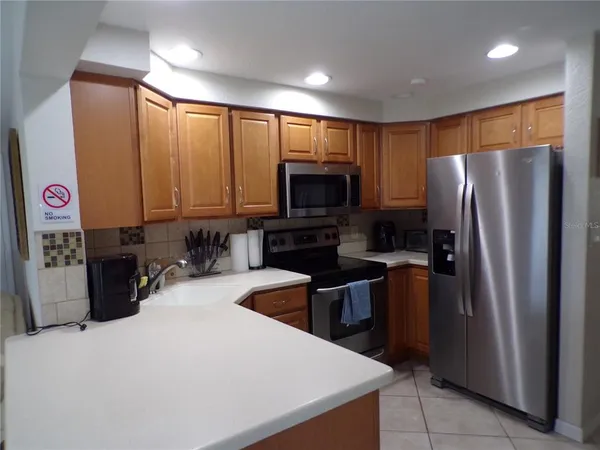 a kitchen with stainless steel appliances a refrigerator a stove a microwave a sink and dishwasher