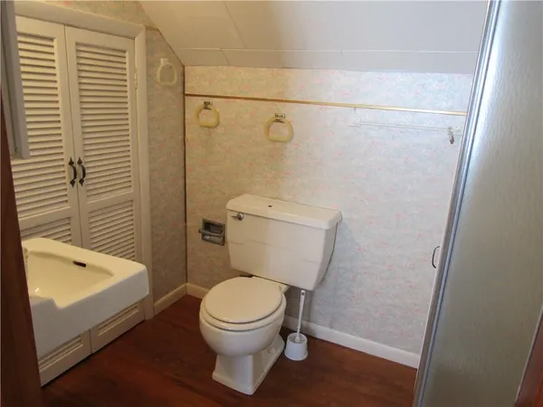 a white toilet sitting next to a bath tub