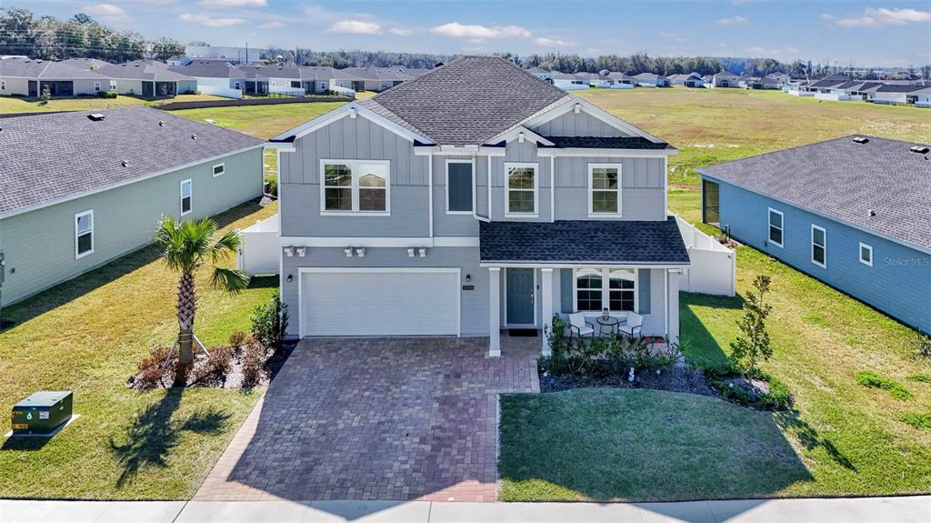 a aerial view of a house with a big yard and large trees