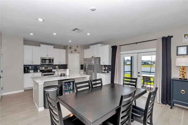 a large kitchen with a table and chairs