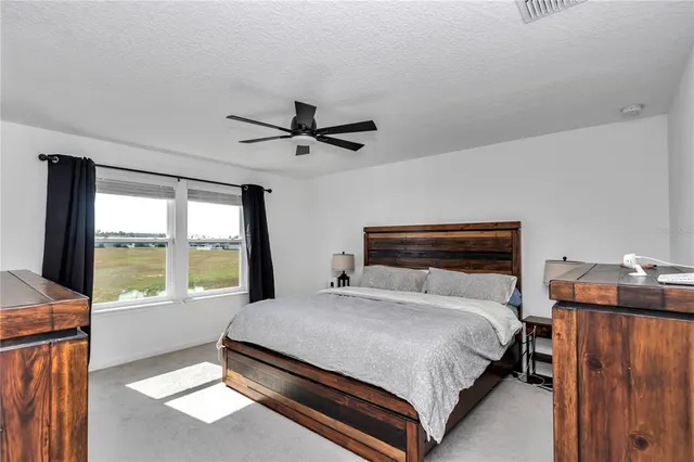 a bedroom with a large bed and a large window