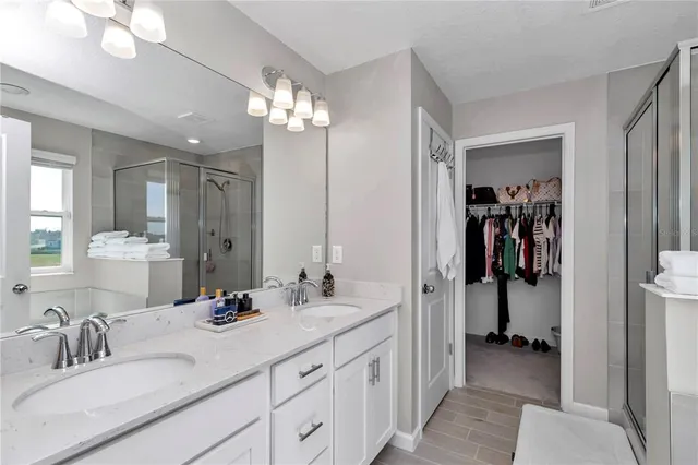 a bathroom with a sink double vanity and a mirror