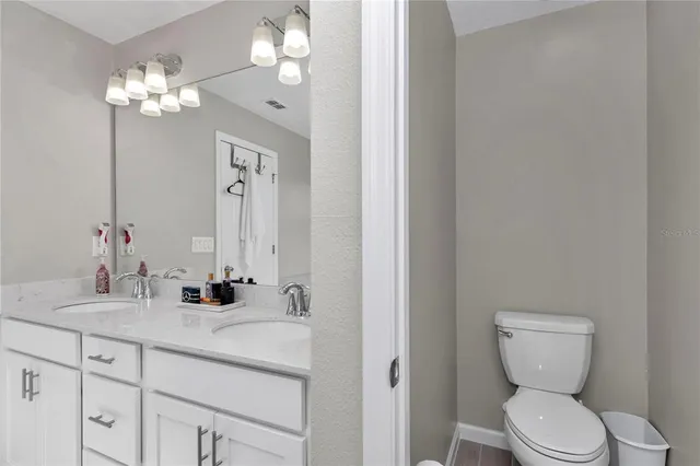a bathroom with a toilet a sink and mirror
