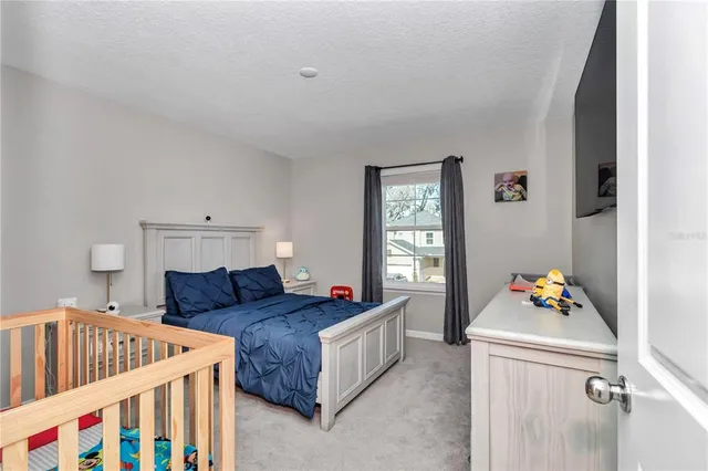 a living room with furniture and a baby crib