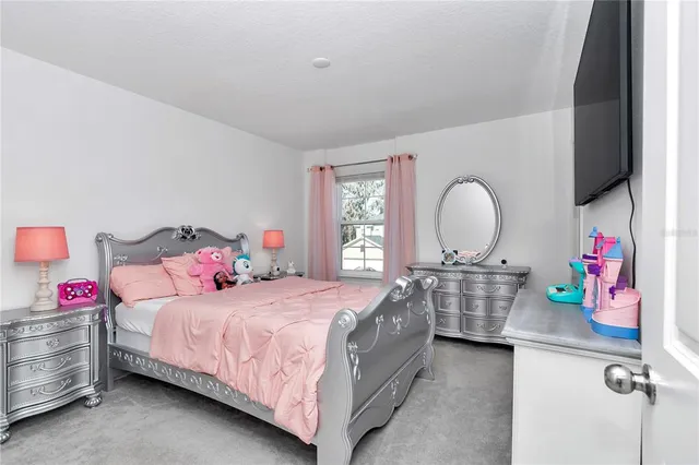 a bedroom with a bed and a dresser