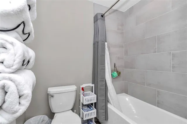 a bathroom with a toilet and shower