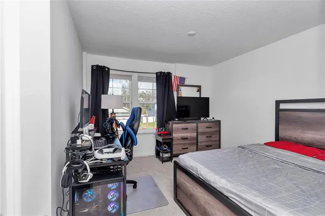 a bedroom with bed and flat screen tv