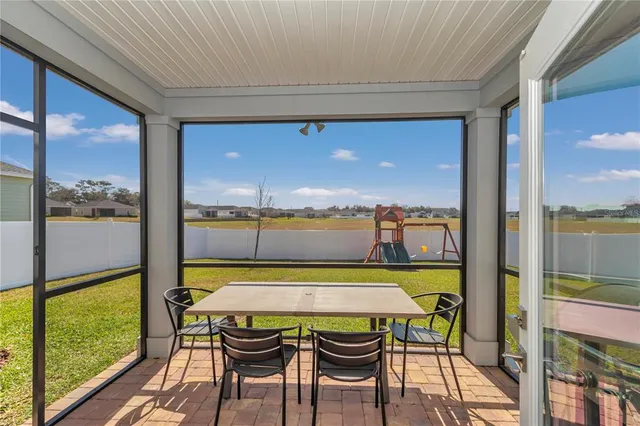 a view of a balcony with table and chairs
