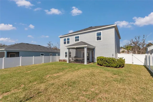 a view of house with yard and entertaining space