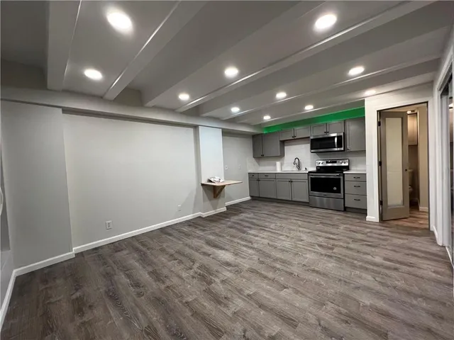 a view of kitchen with a sink and a stove top oven