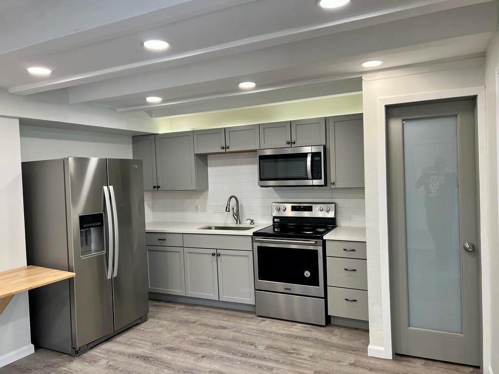 5804 Circulo Drive, Unit 5E Lago Vista, TX 78645 - Photo 3 of 12 a kitchen with stainless steel appliances granite countertop a refrigerator stove and sink